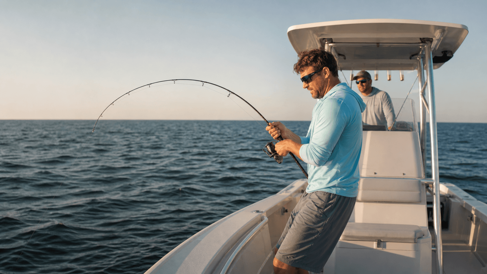 Charter captain coaching an angler aboard an offshore fishing boat